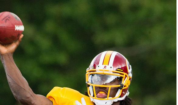 Robert Griffin III throws a pass in training camp at Redskins Park (Photo Courtesy Keith Allison/ Flickr)