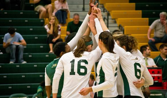The Mason women's volleyball team huddles together during a timeout in last Friday's game. (Photo by Dakota Cunningham)