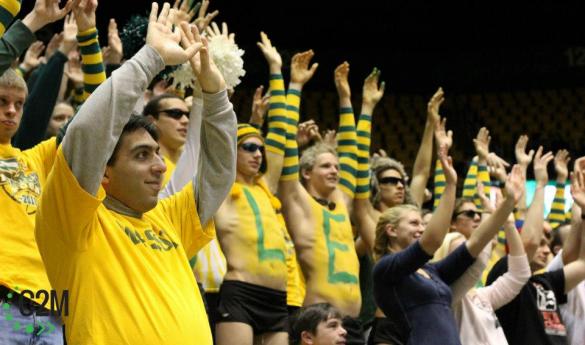 Mason students raise their hands as a player shoots a free throw (Photo by John Irwin). 